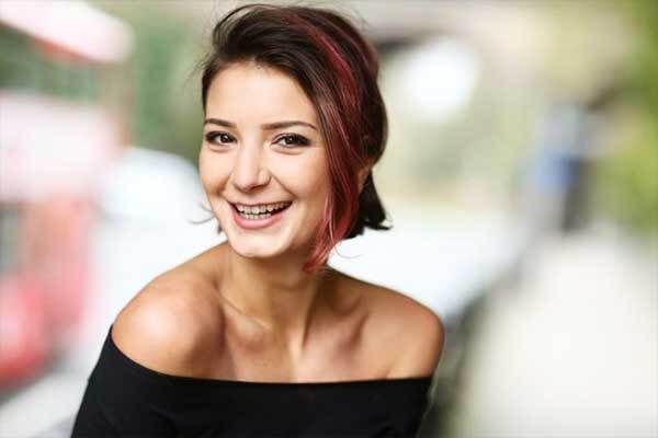 Female Bulgarian voice-over talent smiles at camera.