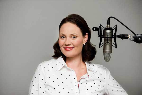 Australian voice-over talent, with red lipstick and dark hair, gets ready to record.